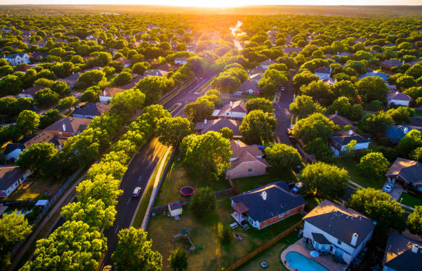 Deep orange glow at Sunset over Vast Homes and Thousands of Houses Modern Suburb Development stock photo