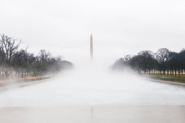 Washington D.C., USA - May 23, 2025. The U.S. Capitol appears at the end of a wide avenue marked by bike lanes and directional signs.