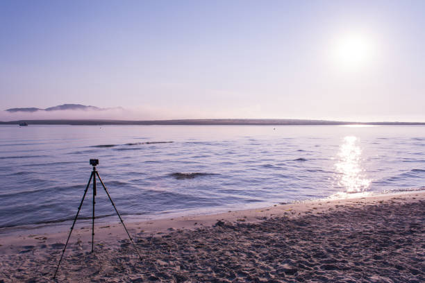 istock compact camera on a tripod on the beach at sunrise 982597946