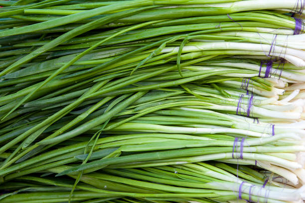 istock Fresh green onion in shop window. 982603630