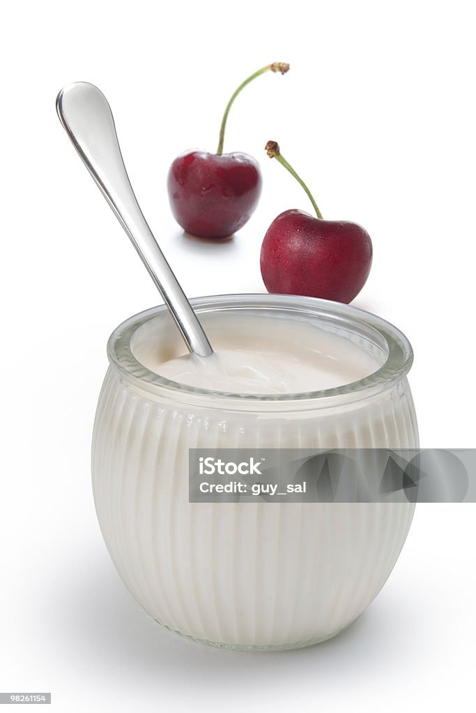 Yogurt in a glass jar with spoon and cherries yogurt in a glass with fresh cherries Breakfast Stock Photo