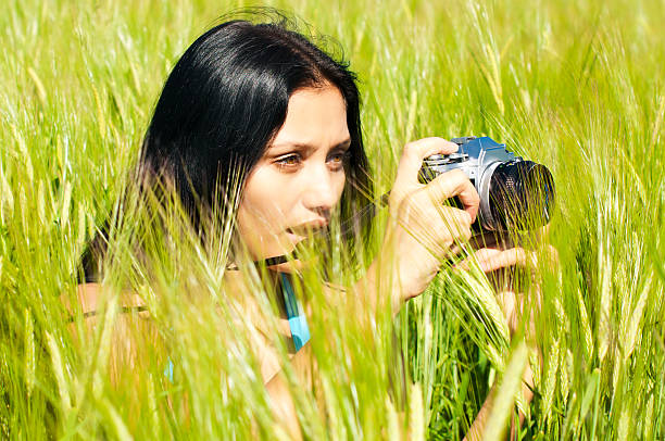 Woman using an analog film camera