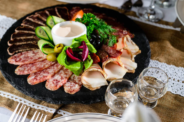 istock Appetizing meat set: beef slices, bacon, salami and vegetables o 982619302