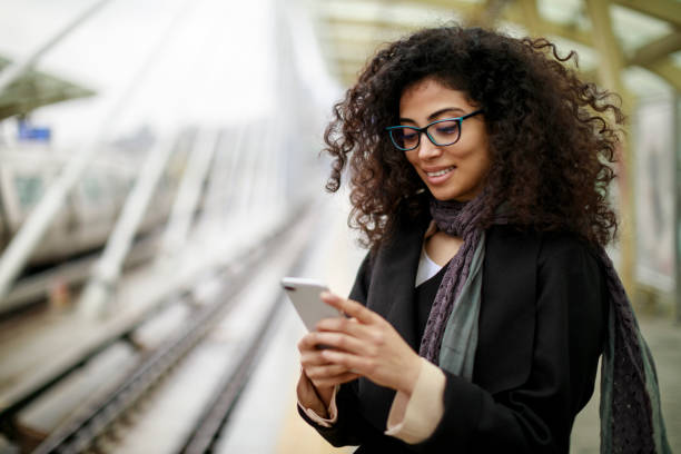 istock Businesswoman using mobile phone at the subway station 982634442