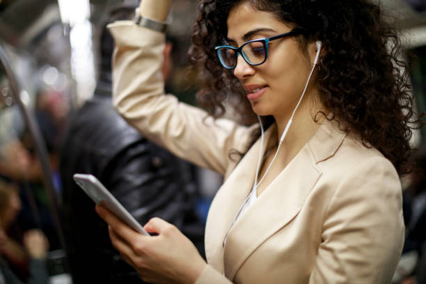 istock Young businesswoman using smartphone while commuting to work by subway 982638238