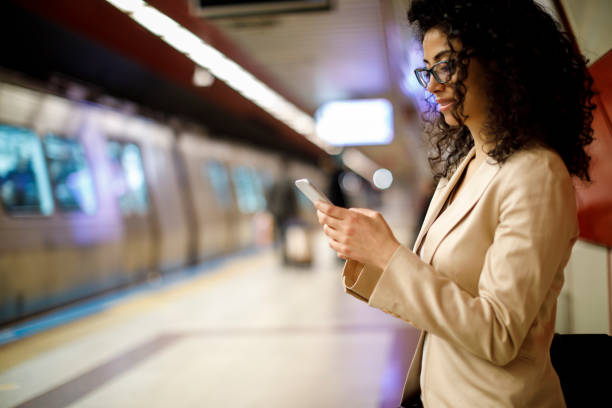 istock Businesswoman using mobile phone on the subway station 982638632