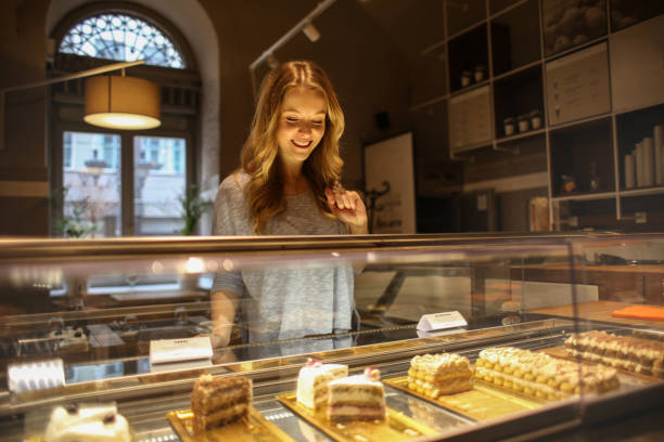 girl choosing a dessert - cake pick imagens e fotografias de stock