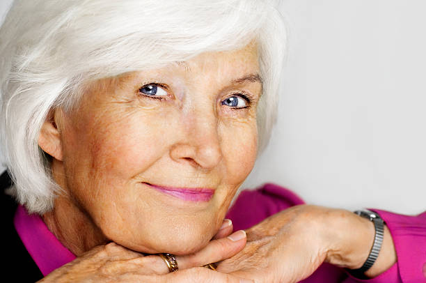istock Senior woman with chin on hands 98265696