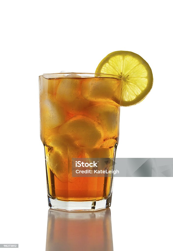 Iced Tea and Lemon (clipping path) A glass full of iced tea with a lemon slice. Beige Stock Photo