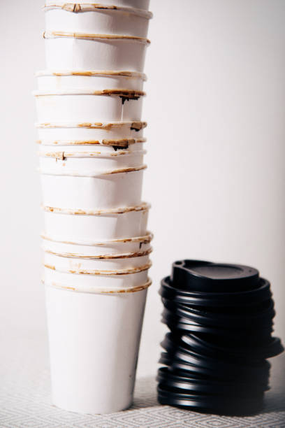 istock Used empty disposable take away coffee cups and plastic lids 982741252