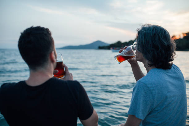 istock Young friends enjoying sunset at a beach 982742182