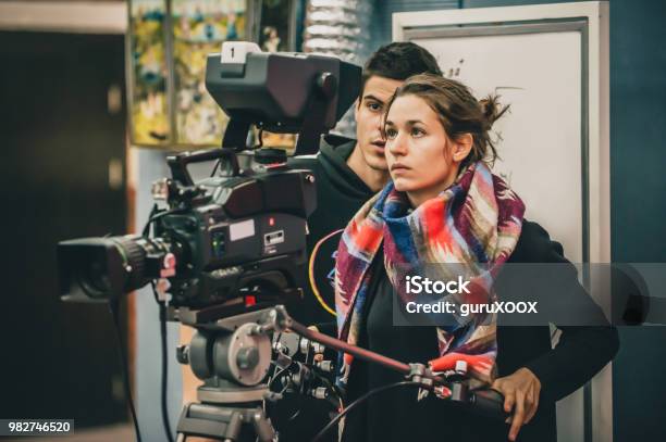 Behind The Scene Cameraman And Assistant Shooting Film With Camera Stock Photo - Download Image Now