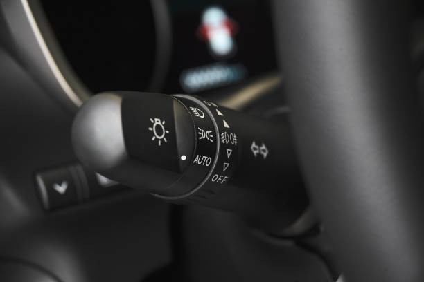 istock Changing headlight stick of modern car close-up. Car light control system 982747518
