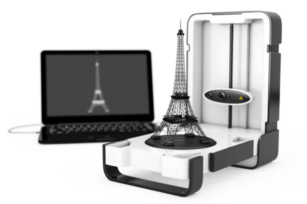 istock Free Standing Modern Desktop Home 3D Scanner Connected to Laptop and Scanning Eiffel Tower Object. 3d Rendering 982755288