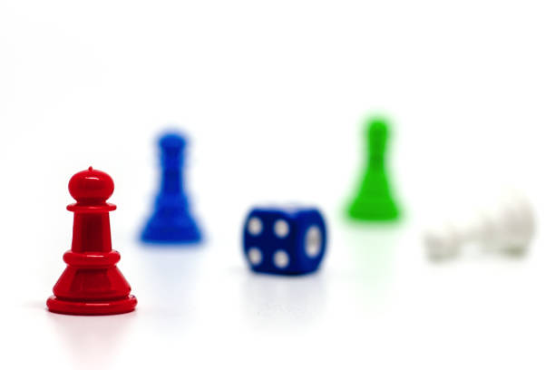 istock Selective focus of red chess pawn on blurred others and dice against white background for leadership concept 982757494