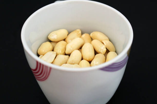 Detail of delicious peanuts in white cup stock photo