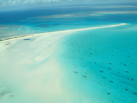 Panoramic view of one of the atolls in the Maldives from a bird's eye view. A thin strip of land of sand connecting the larger parts of the island. Aerial seamless 360 degree spherical panorama