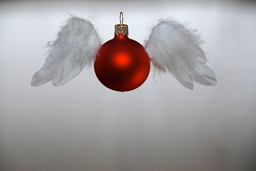 Beautiful little angel and balls on the Christmas tree. Festive decoration