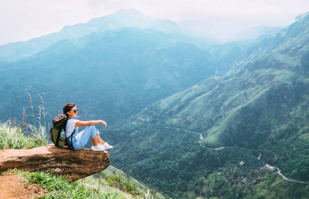 Traveler woman enjoy with mountains landscape. Travel concept vacations hiking with backpack in mountains Traveler woman enjoy with mountains landscape. Travel concept vacations hiking with backpack in mountains ella sri lanka stock pictures, royalty-free photos & images