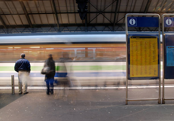 istock railway platform with incoming train and waiting passenger 98276909