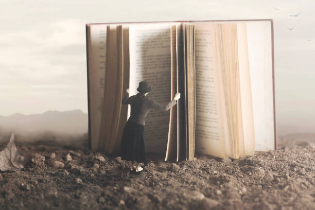 surreal image of a curious woman leafing through a giant book - nature writing women ideas imagens e fotografias de stock