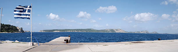 istock panoramic view with Greek flag and mediterranean sea 98277235