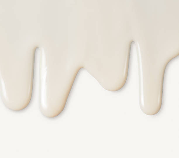 istock Dripping white milk, cream, paint yogurt on white background 982775200