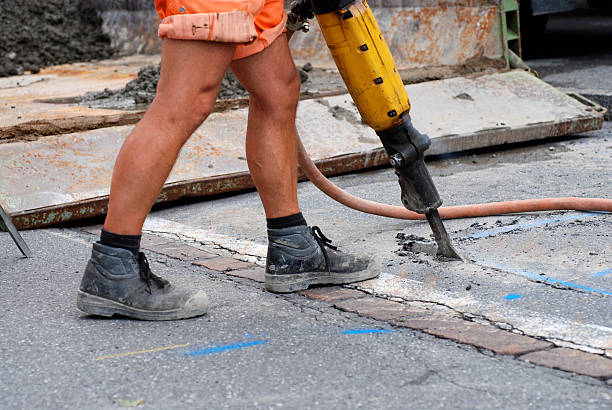 istock roadman with jackhammer at roadworks 98277538