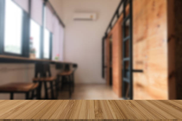 istock cafe coffee shop cafeteria blur background with wood table for display product 982779892