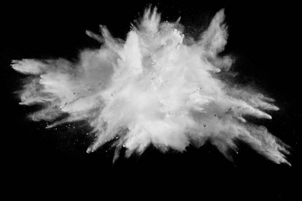 istock Launched white powder splash on black background. Bizarre forms of of white powder explosion cloud against dark background. 982780708