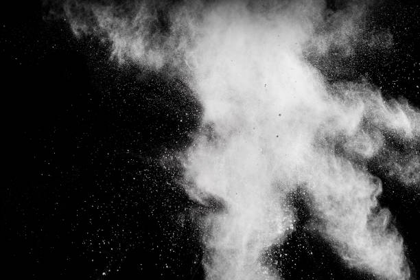 istock Launched white powder splash on black background. Bizarre forms of of white powder explosion cloud against dark background. 982780742