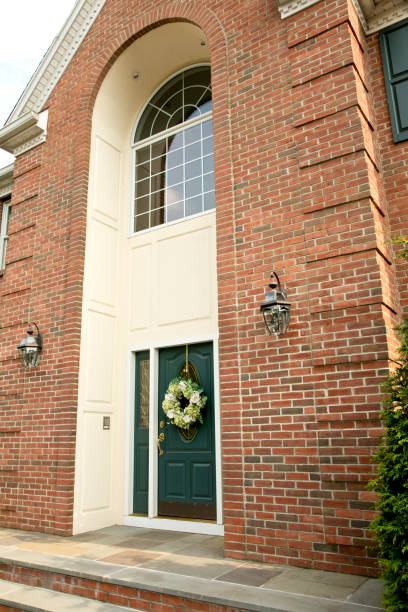 istock Front Door with flowered wreath on luxury home facade 982784026
