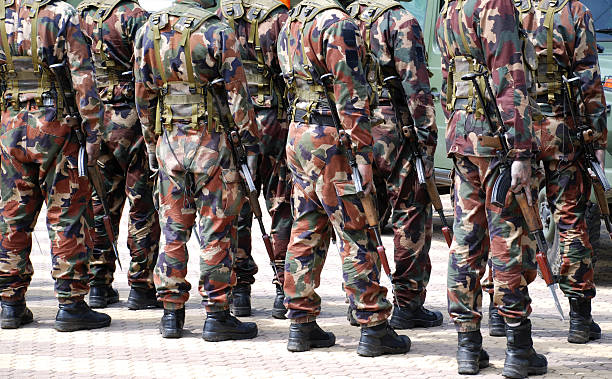 istock soldiers in camouflage suit with machine gun 98279055