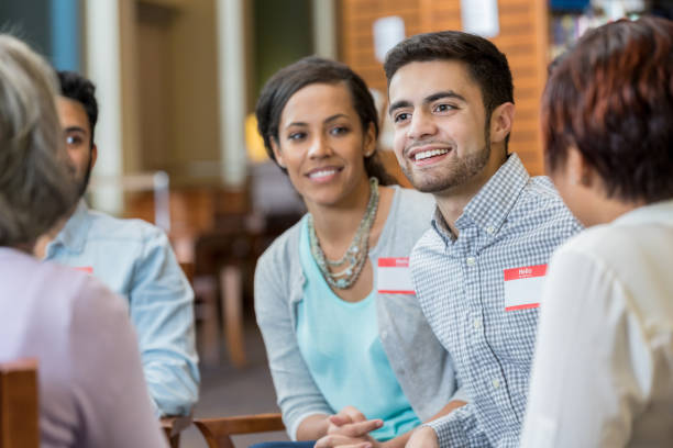 istock Young man discusses something in support group meeting 982800486