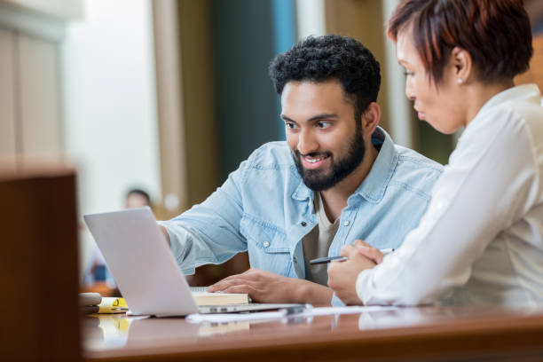 istock Male and female students use laptop 982800492