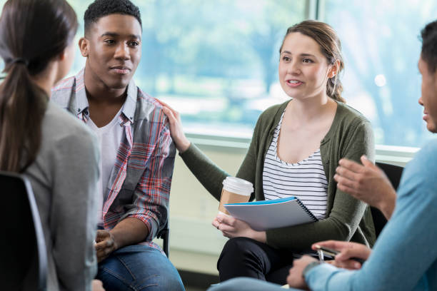 istock Woman discusses something in group therapy 982800668