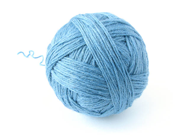 Skein of thread with drawn details is presented in the form of a cute mouse. Blue ball of woolen thread on a light background with copy space