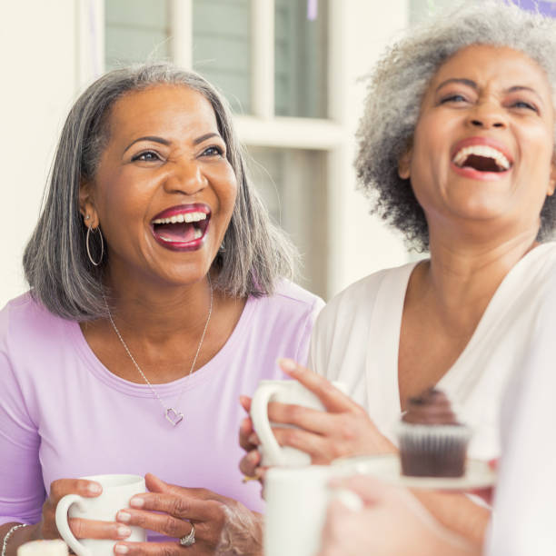istock Senior sisters laugh together during charity fundraiser 982800818