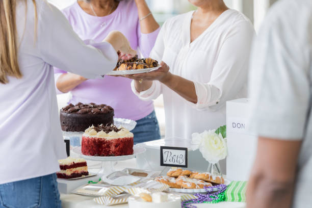 istock Unrecognizable volunteers sell desserts during charity event 982800826