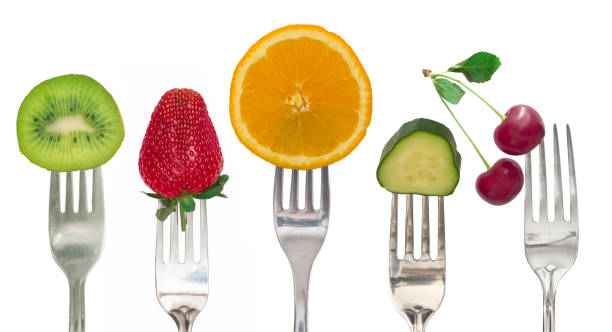 istock Diet concept, fruit and vegetables on the forks 982804184