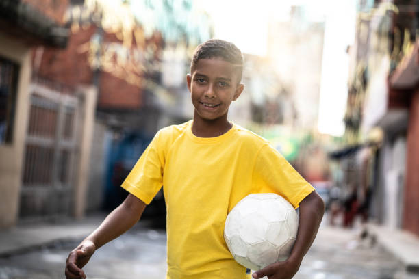 istock Brazilian Kid Playing Soccer Portrait 982807580