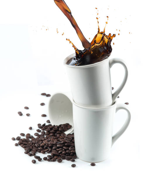 istock Coffee splash with Stacked white coffee cups isolated on white background 982815126