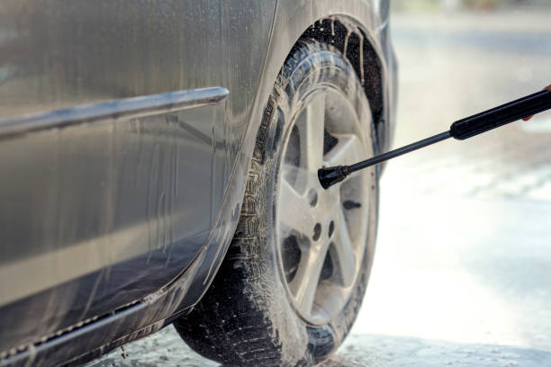 istock Cleaning like a professional- man cleaning his car with a microfiber cloth 982819150