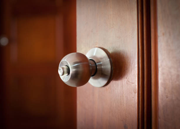 istock door handle keyhole with old design on brown wood door 982820048