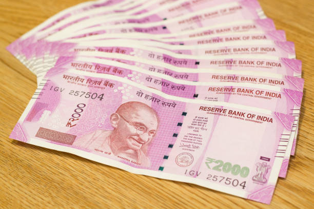 istock Indian rupees laying on wooden table 982822830