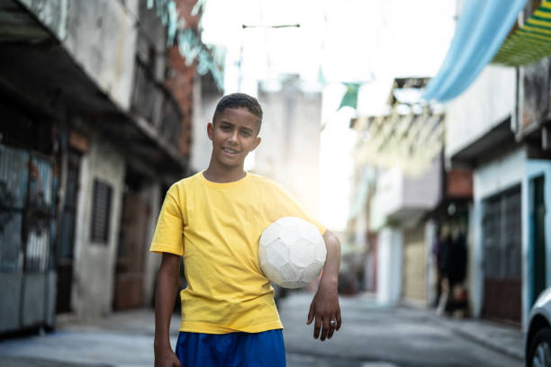 istock Brazilian Kid Playing Soccer Portrait 982825884