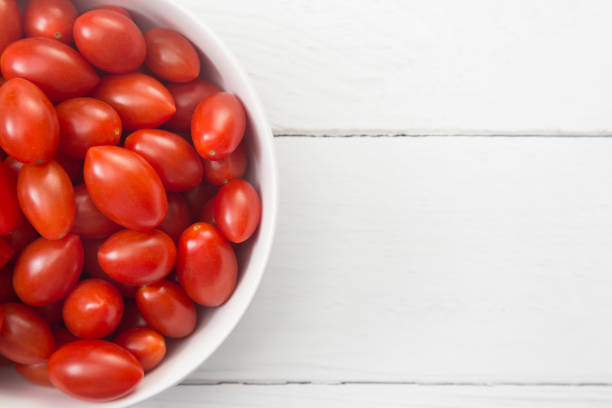 istock Grape Tomatoes in a White Bowl on a White Wood Table 982825894