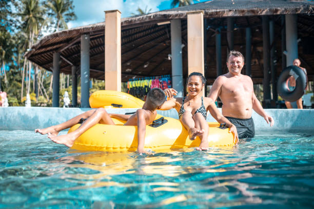 istock Family enjoying on inflatable ring at park 982826778