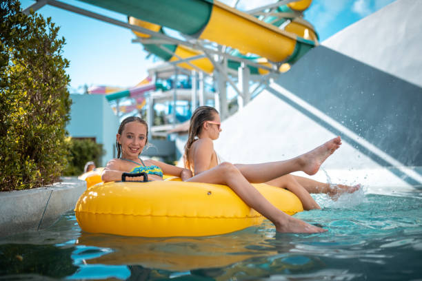 istock Sisters enjoying on inflatable ring at park 982826826
