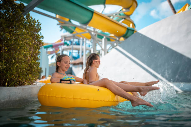 istock Sisters enjoying on inflatable ring at park 982826832